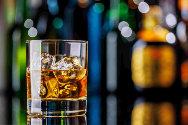 Whiskey on the rocks on a bar table