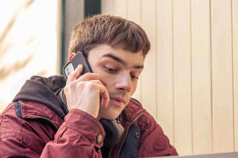 young man talking to parents on phone